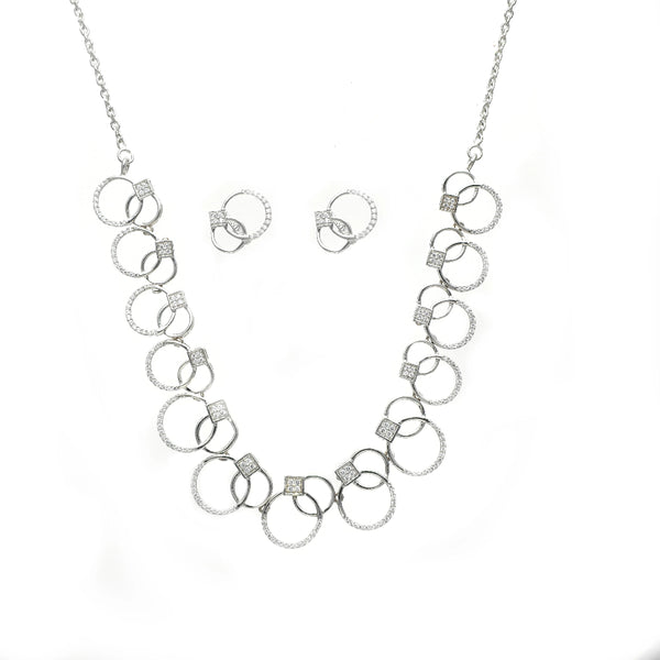 Silver necklace and earrings set on a white background